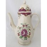 A circa 1790 cream ware coffee pot with purple flower decoration.