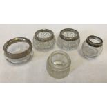 A small collection of silver rimmed salts and pots.