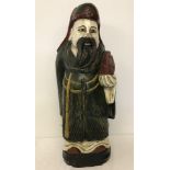 A carved and painted wooden Chinese figure.