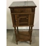 A small light oak marble topped hall cupboard.