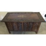 A vintage carved occasional table with inlaid detail to top.