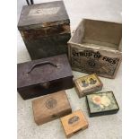 A collection of cardboard, wood and tin boxes.