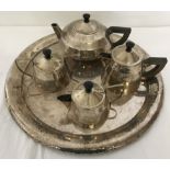 An Art Deco silver plated 4 piece tea set on a circular hammered effect tray.