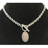 A hallmarked silver belcher style necklace with T bar fastening and blank oval pendant.