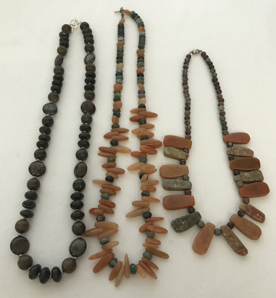 3 natural stone necklaces to include carnelian and agate in shades of brown.