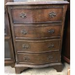 A small vintage serpentine fronted 4 drawer chest of drawers with drop down handles.