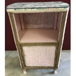 A vintage loom basket ware bedside cabinet in pink and gold.