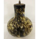 An Art glass bulbous shaped lamp base of mottled brown effect glass.