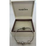 A boxed Pandora charm bracelet with 3 charm beads.