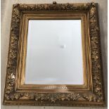 A French 19th century gilded ornate salon mirror with bevelled edge.