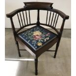 A Victorian corner chair with turned rail back, inlaid banding, cross stretcher and tapestry seat.