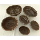 6 vintage brown stoneware jelly moulds of various sizes and design.