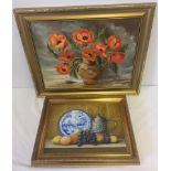 2 gilt framed oil on boards depicting still life.