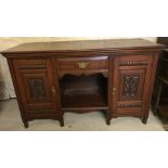 A Victorian mahogany sideboard with carved detail to front and original brass handles.