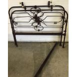 A vintage burgundy painted and brass single bed frame.