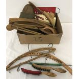 A collection of vintage branded wooden coat hangers and clothes brushes.