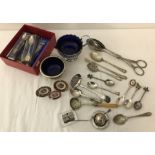 A collection of cutlery items to include boxed teaspoons, aspargus tongs and strainer spoons.