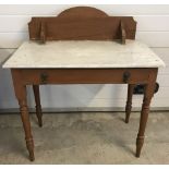 A Victorian pine washstand with single drawer and wooden back board.