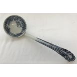 A Victorian ceramic ladle with flo blue decoration to bowl and handle.