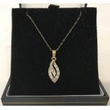 A 9ct gold pendant set with approx 10 small diamonds.
