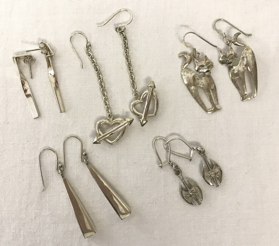 5 pairs of silver earrings of different designs.