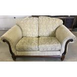 A cream coloured 2 seater settee with chenille upholstery.