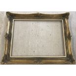 A large ornate gilt picture frame.