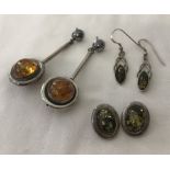 3 pairs of silver earrings set with amber.