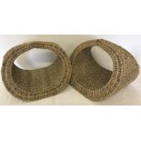 A pair of ornamental wicker display baskets.