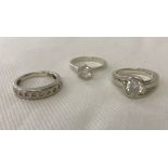 3 silver dress rings set with clear stones.