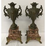A pair of marble & spelter garnitures.