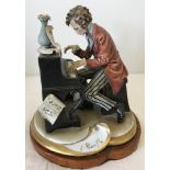 A Capodimonte figurine of a gentleman playing the piano.