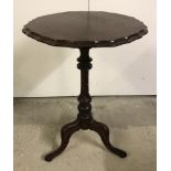 A vintage mahogany tripod based wine table with piecrust edge and turned pedestal.