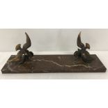 An Art Nouveau style picture frame base of a pair of brass birds mounted on a red marble base.