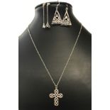 A silver cross and chain and 2 pairs of silver earrings all in a Celtic design.