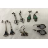 5 pairs of silver earrings set with stones.