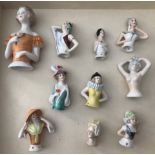 A collection of 10 vintage porcelain half dolls.