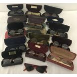 A collection of cased vintage spectacles to include horn rimmed, wire rimmed and sunglasses.
