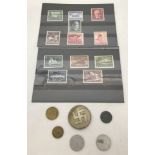 A collection of German WWII pattern coins and stamps together with a pin back party badge.