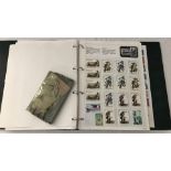 A Green ring binder stamp album containing world stamps.