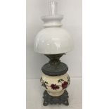 A vintage Hinks & sons oil lamp with ceramic bowl with red flower painted decoration.