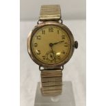 A vintage 9ct gold case gents wristwatch with Fixoflex patterned rolled gold strap.