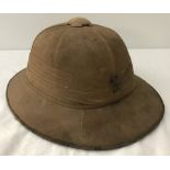 A khaki military pith helmet.