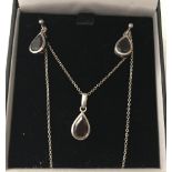 A silver and Garnet drop pendant necklace with matching drop earrings.