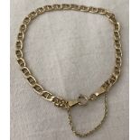 A 9ct gold anchor link chain bracelet with safety chain.