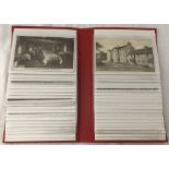 A slim red album of vintage postcards and photographs.