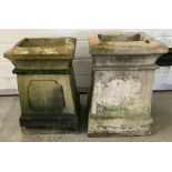 A pair of concrete square shaped garden planters.