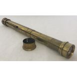 A vintage brass telescope/optical instrument.