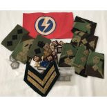 A collection of military cloth badges, clasps and a armband.