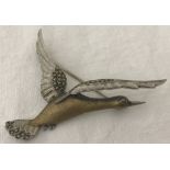 A silver and marcasite 'duck taking flight' brooch.